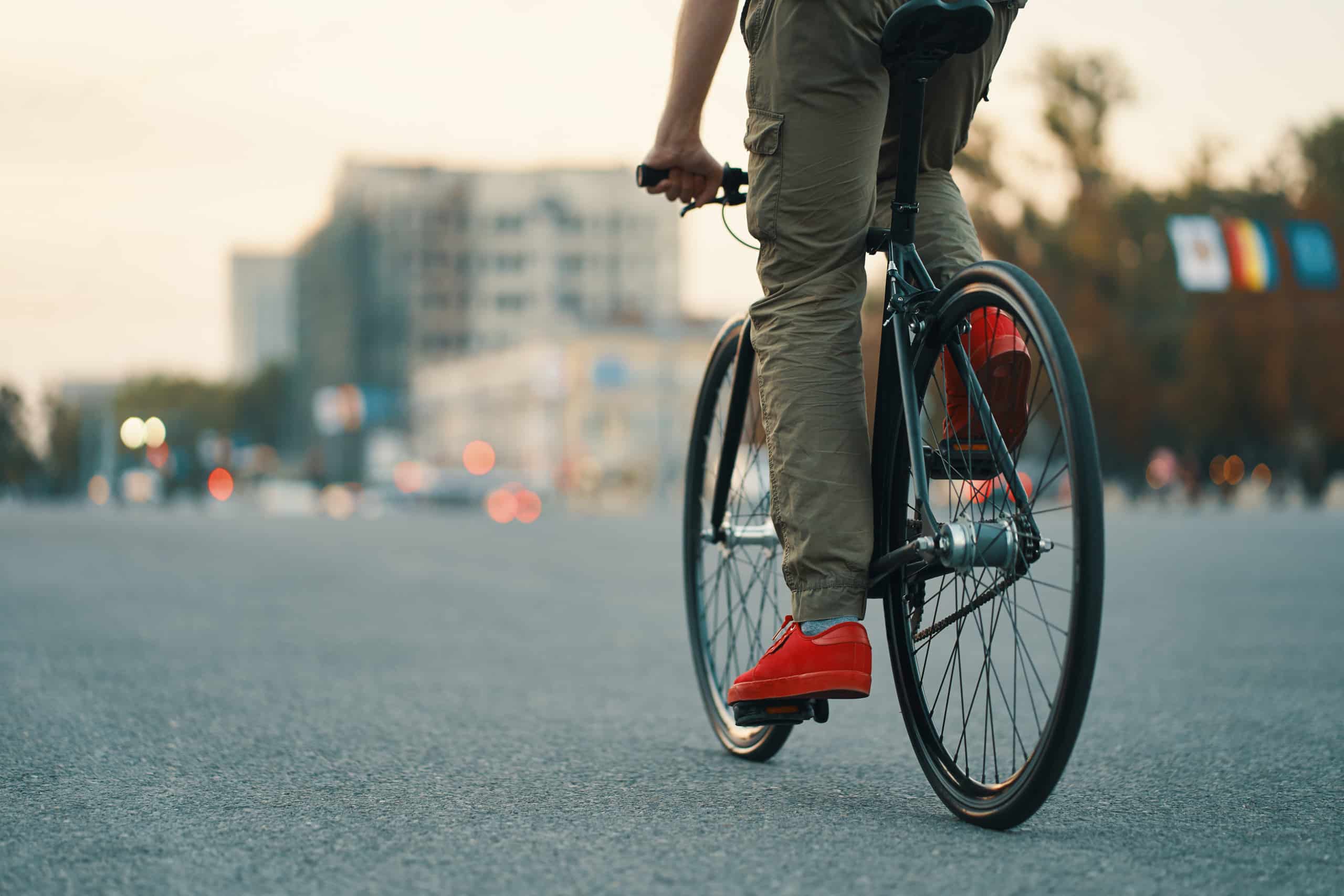 closeup-casual-man-legs-riding-classic-bike-city-road-1-scaled